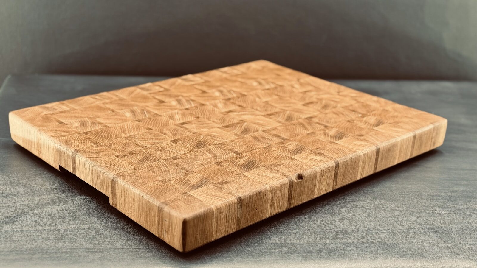 Wooden cutting board with a textured surface, showcasing a beautiful grain pattern. Ideal for cooking and kitchen aesthetics.